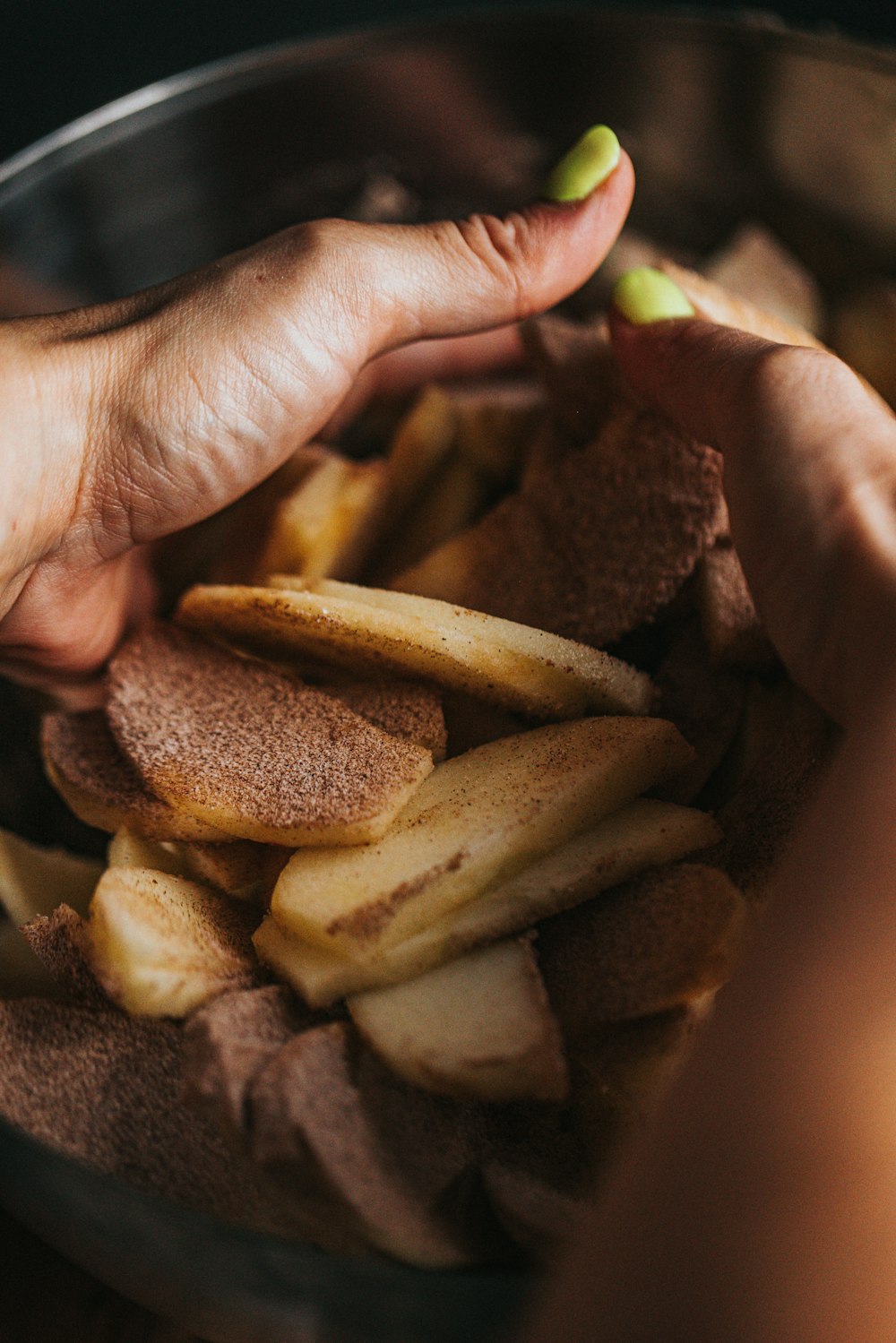 person holding brown bread with brown sauce