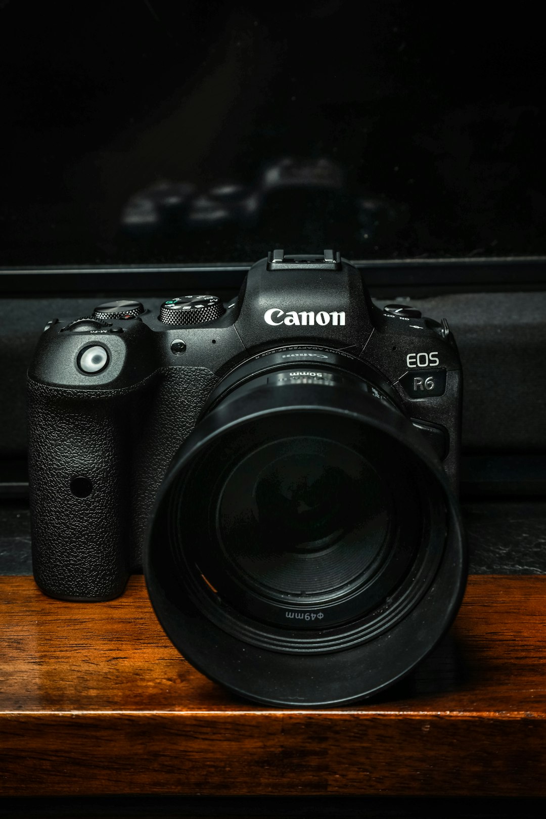 black nikon dslr camera on brown wooden table