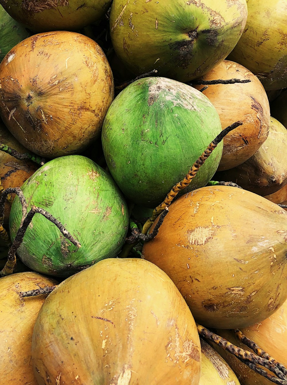 green and brown fruit on brown wooden table