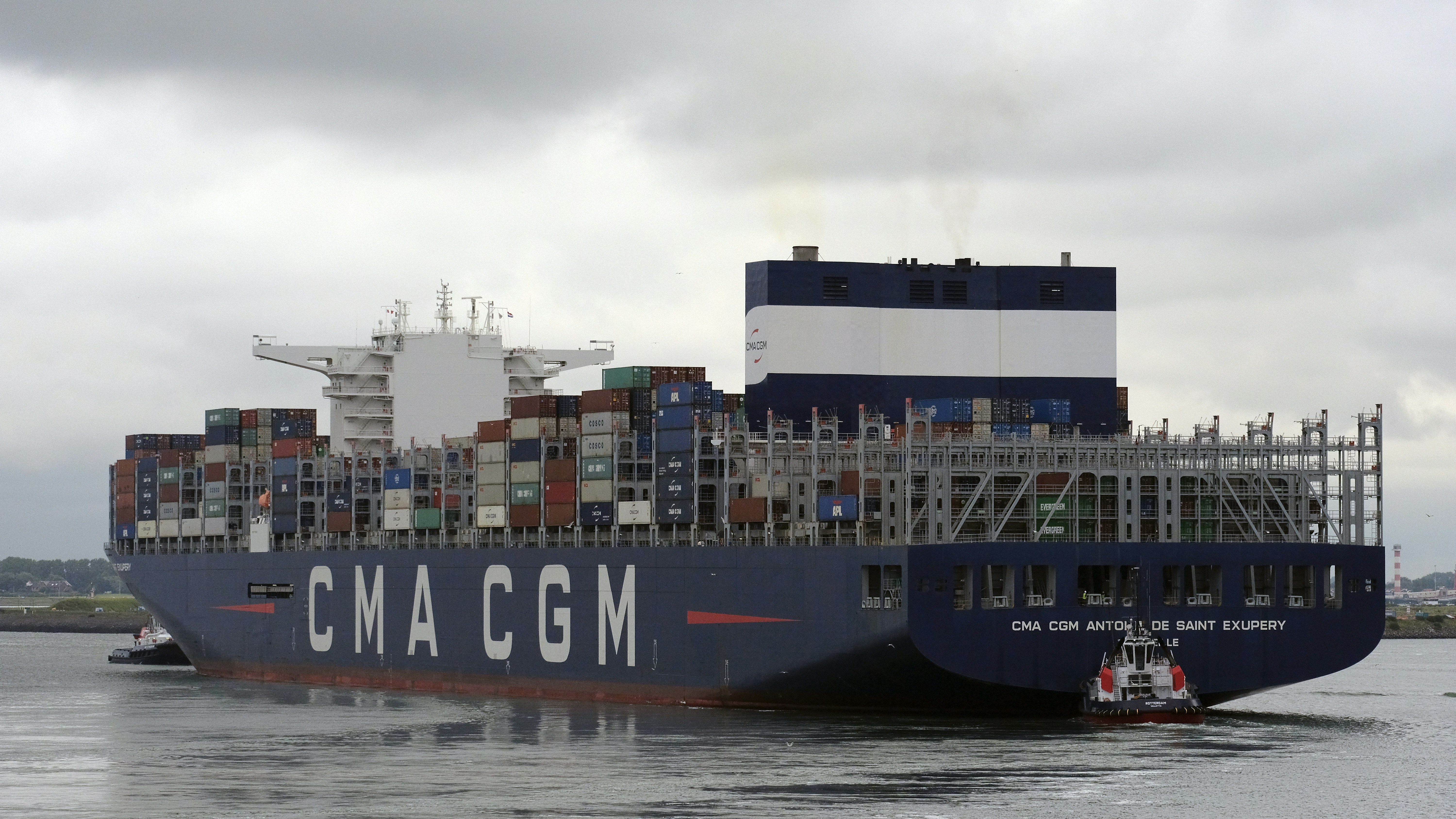black cargo ship on sea under white sky during daytime