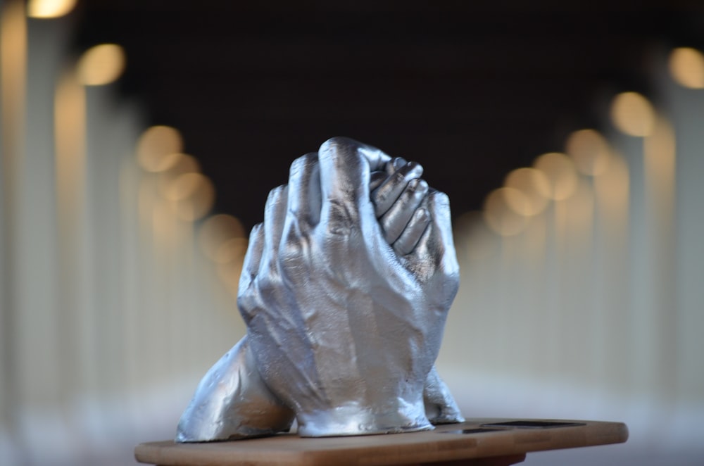 white ceramic figurine on brown wooden table