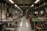 red and white dining tables and chairs in a t-shirt factory