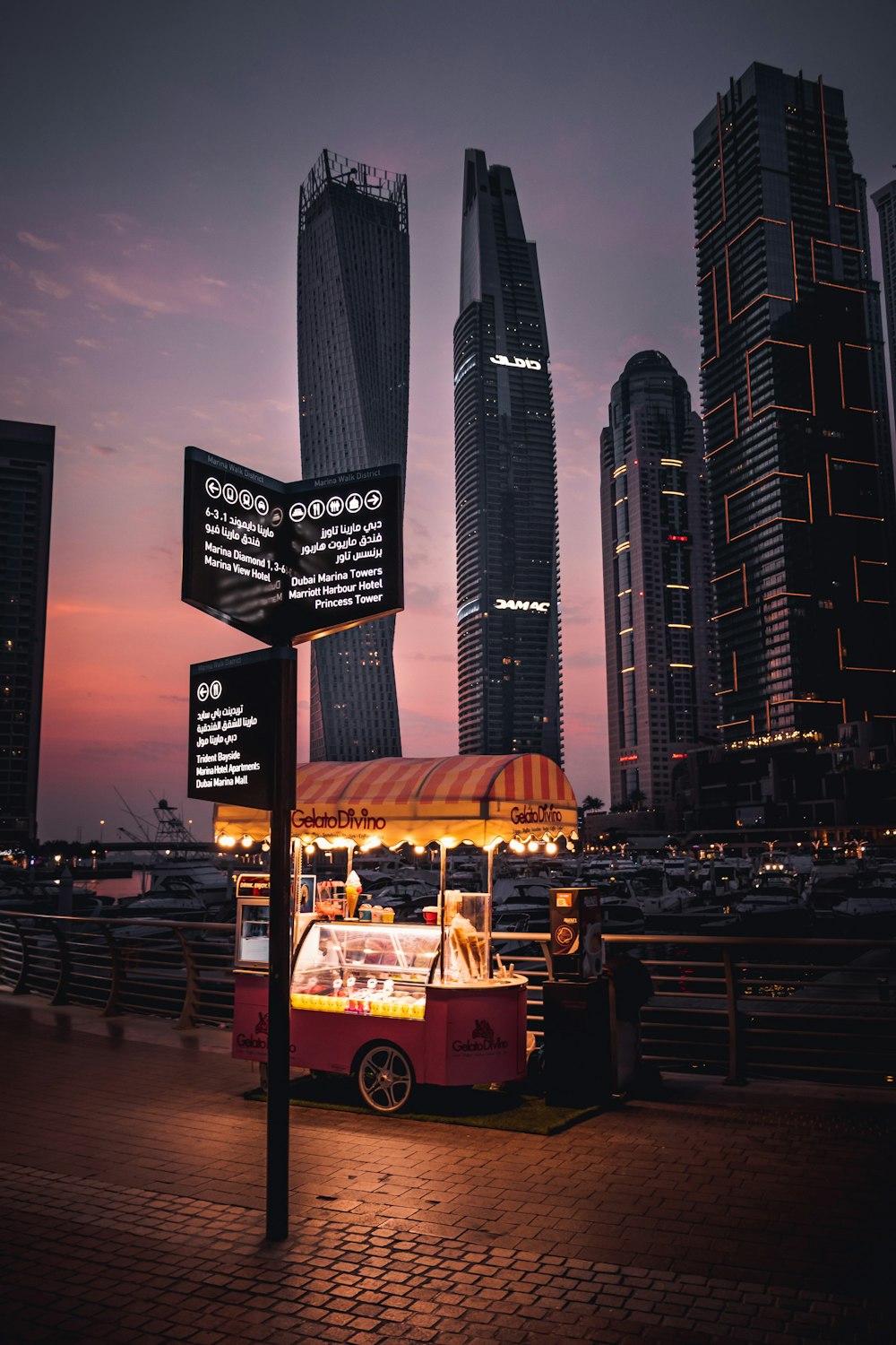 gelato cart near high rise buildings during night time