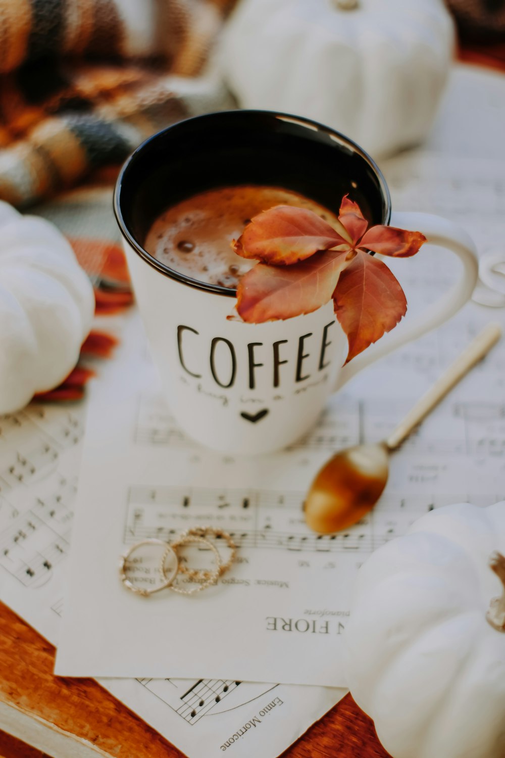 white ceramic mug with brown liquid inside