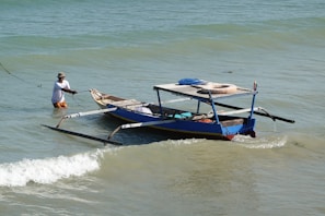 Local guide steering a panga boat with surfers heading out to the waves