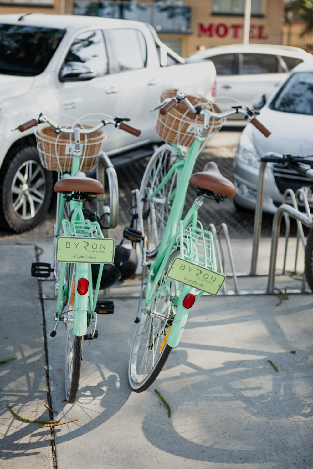 green city bike parked on gray pavement during daytime