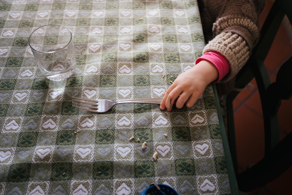 person holding stainless steel fork