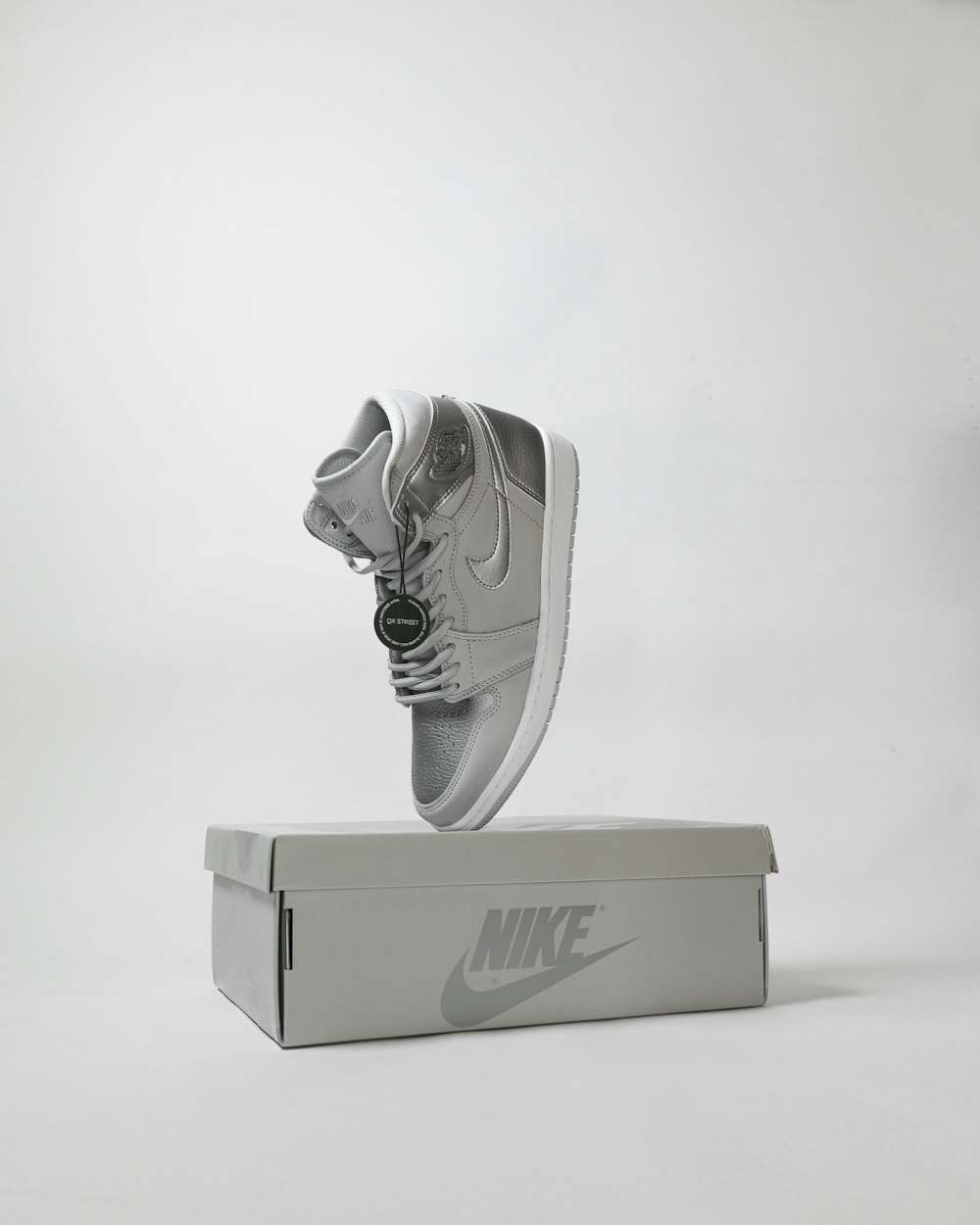 gray and white nike shoe with box