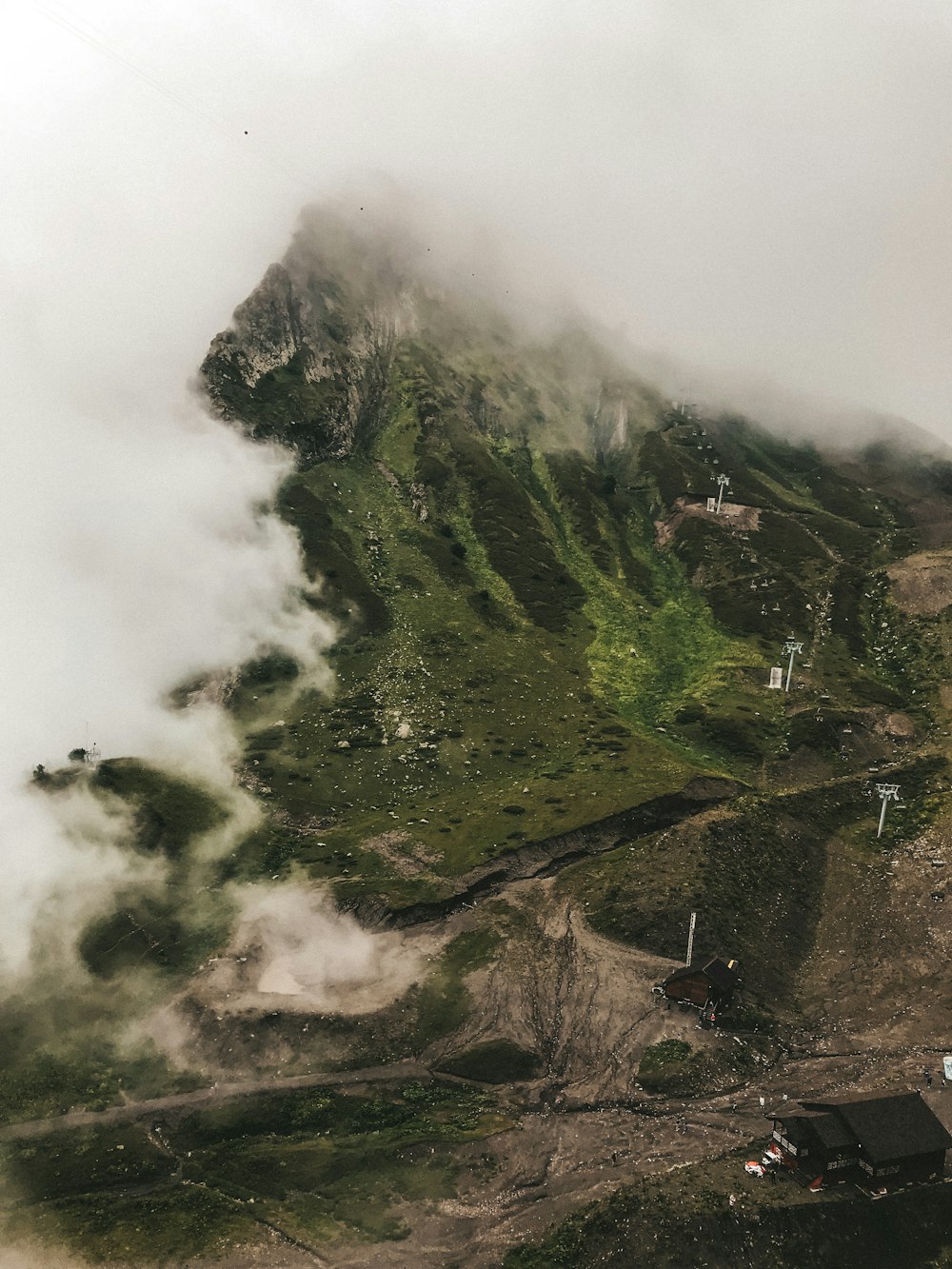 green mountain covered with white clouds during daytime