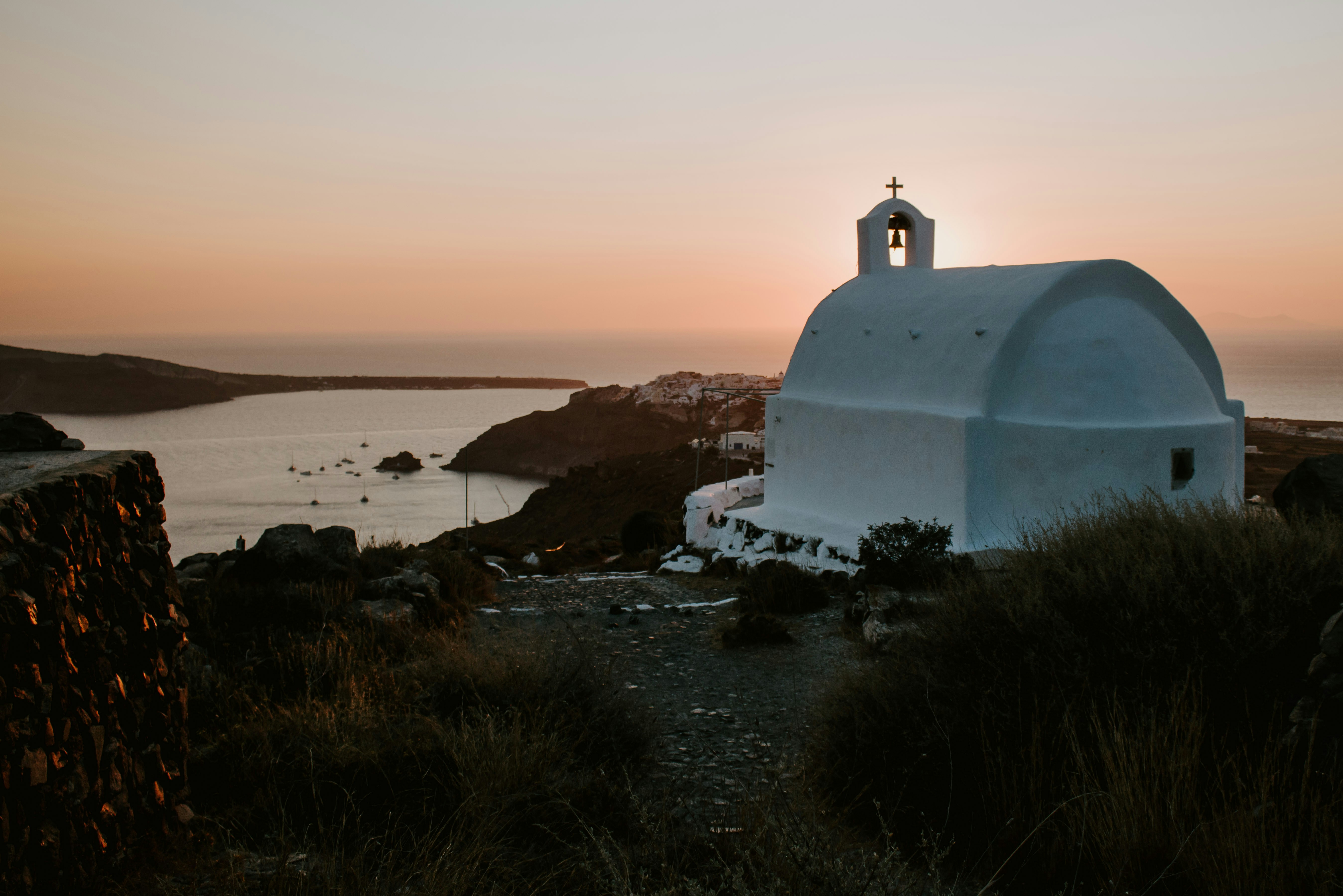white concrete building near body of water during daytime
