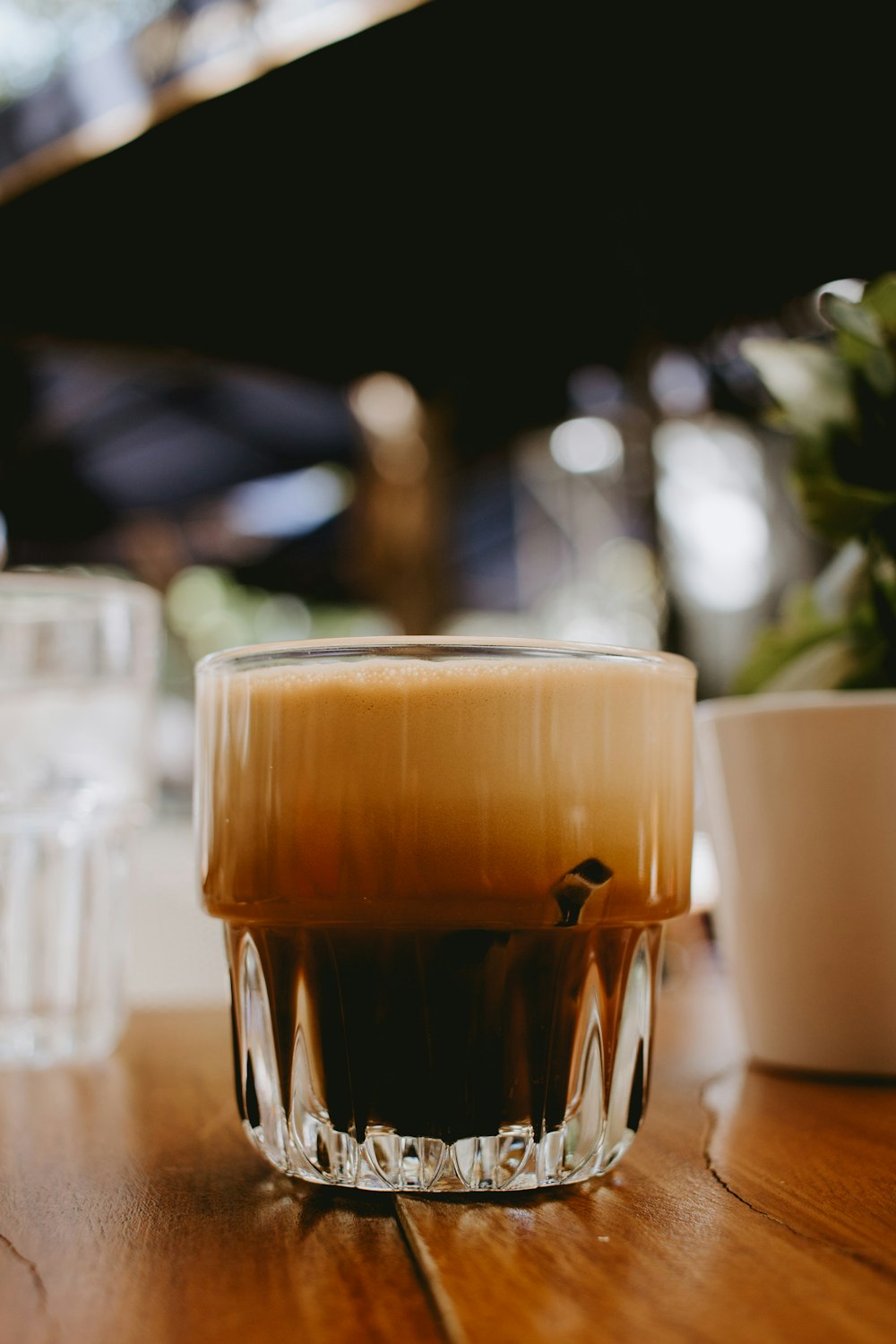 clear drinking glass with brown liquid