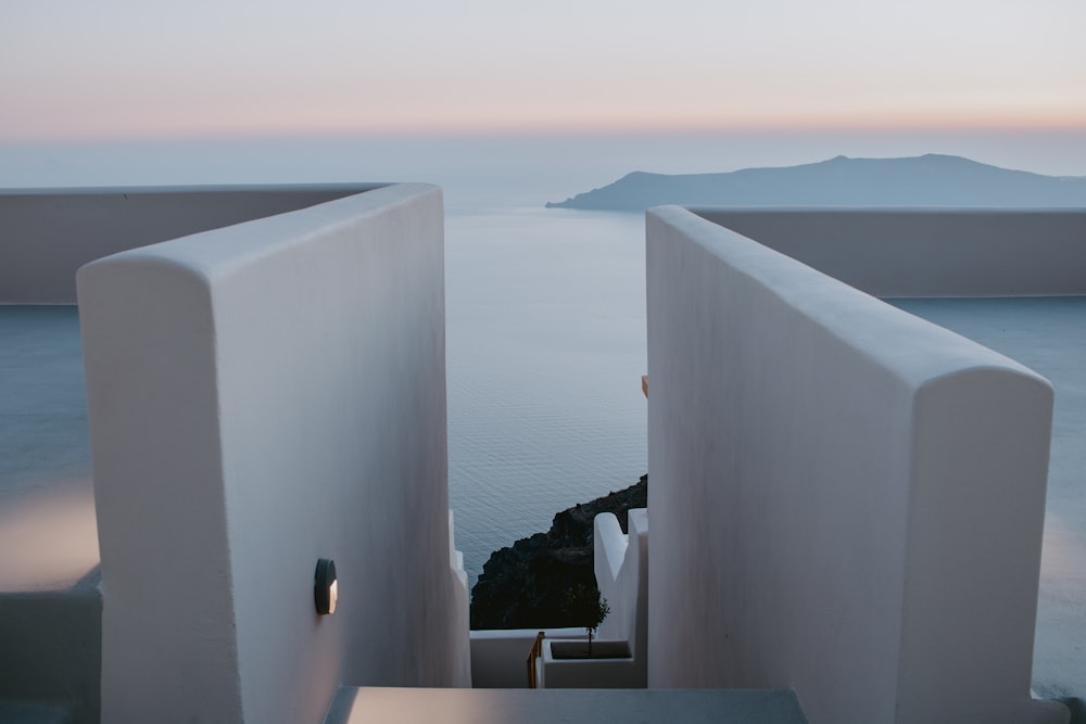 white concrete wall near body of water during daytime