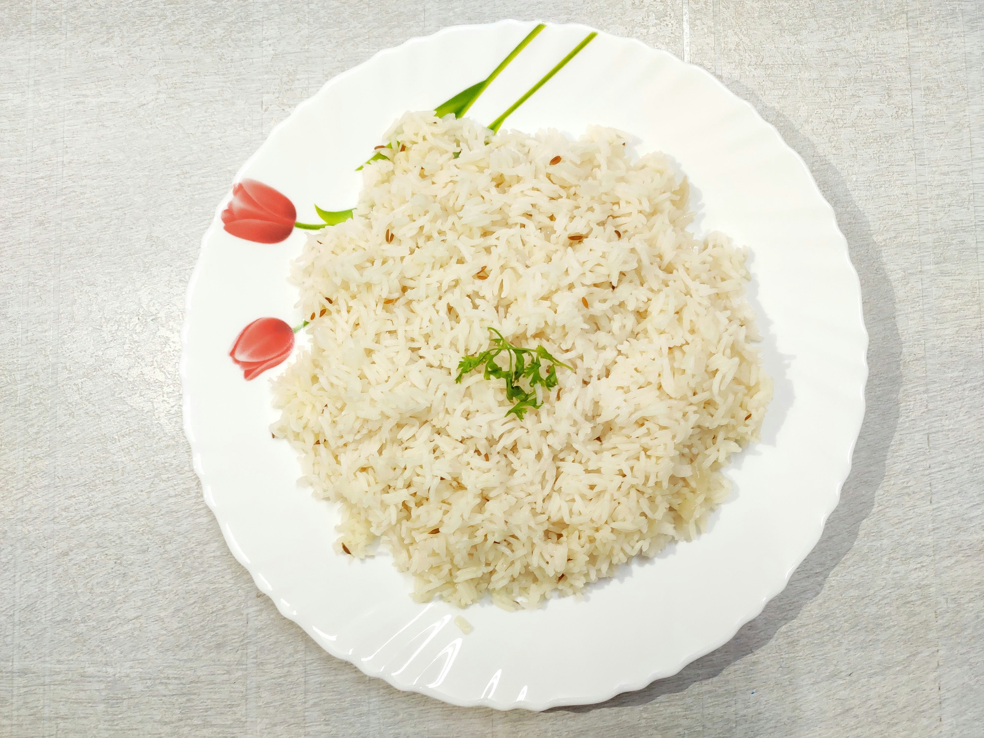Bright yellow Java rice on a white plate with cilantro garnish, fluffy and aromatic