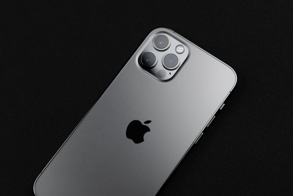 silver iphone 6 on black surface