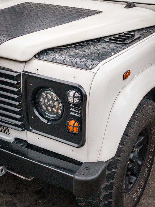 Front view of a Hino 300 Series 136 HDX 4x4 truck on a rugged terrain