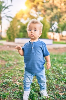 A toddler playing outdoors dressed in comfortable casual wear