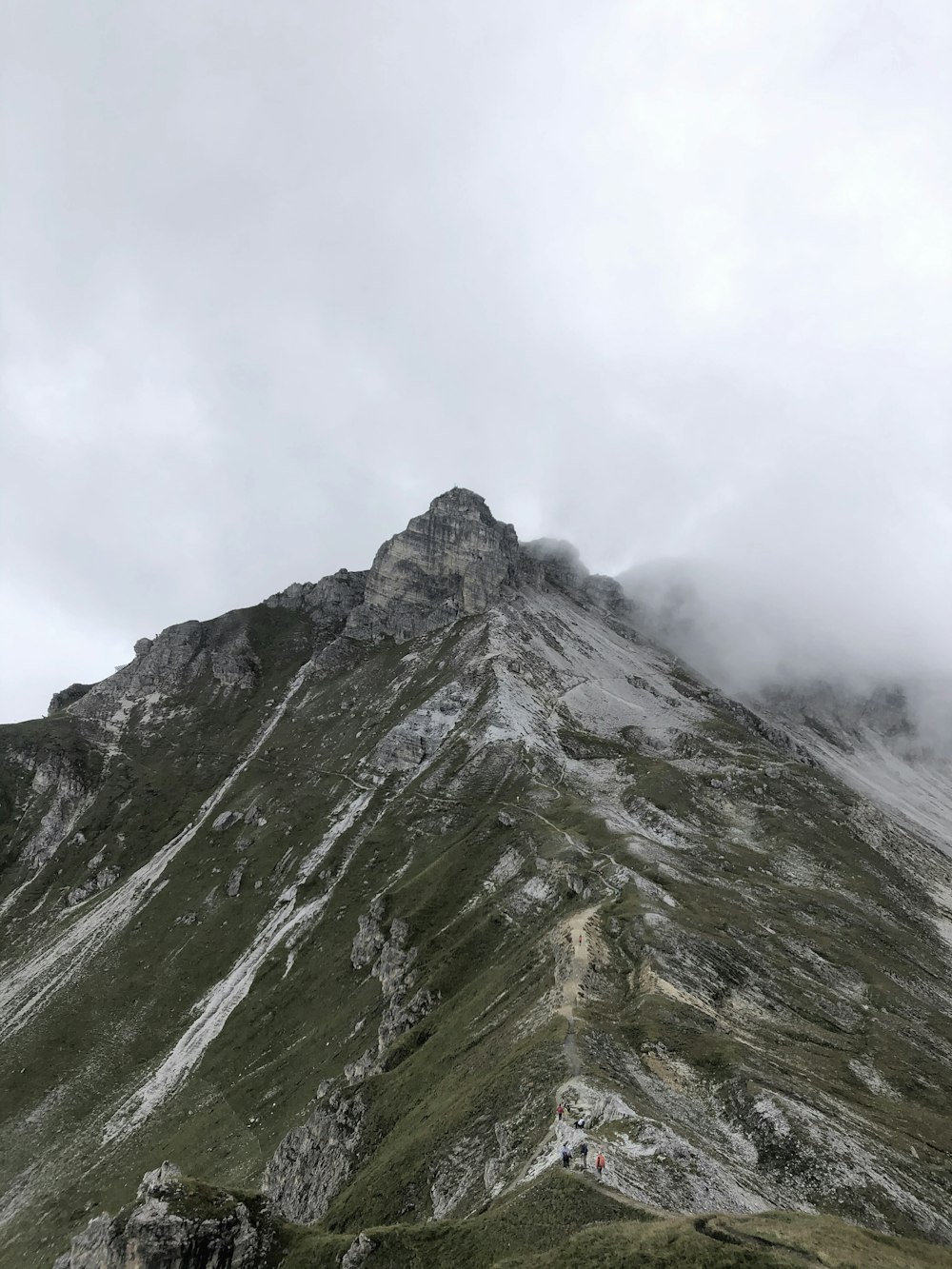 green and gray mountain under white clouds during daytime