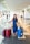 A happy woman exploring a new city with her luggage.