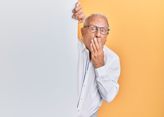 man in white dress shirt wearing black framed eyeglasses