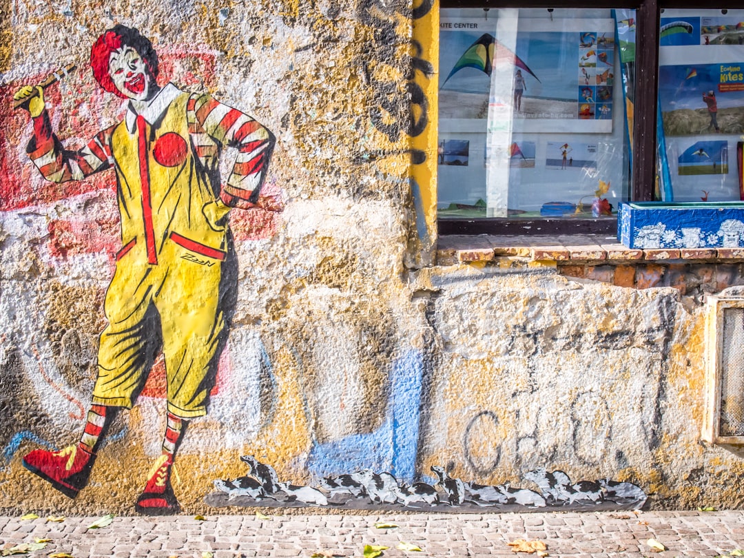 man in yellow and red suit painting, Ronald McDonald @ Feinkost eG Leipzig (followed by rats)