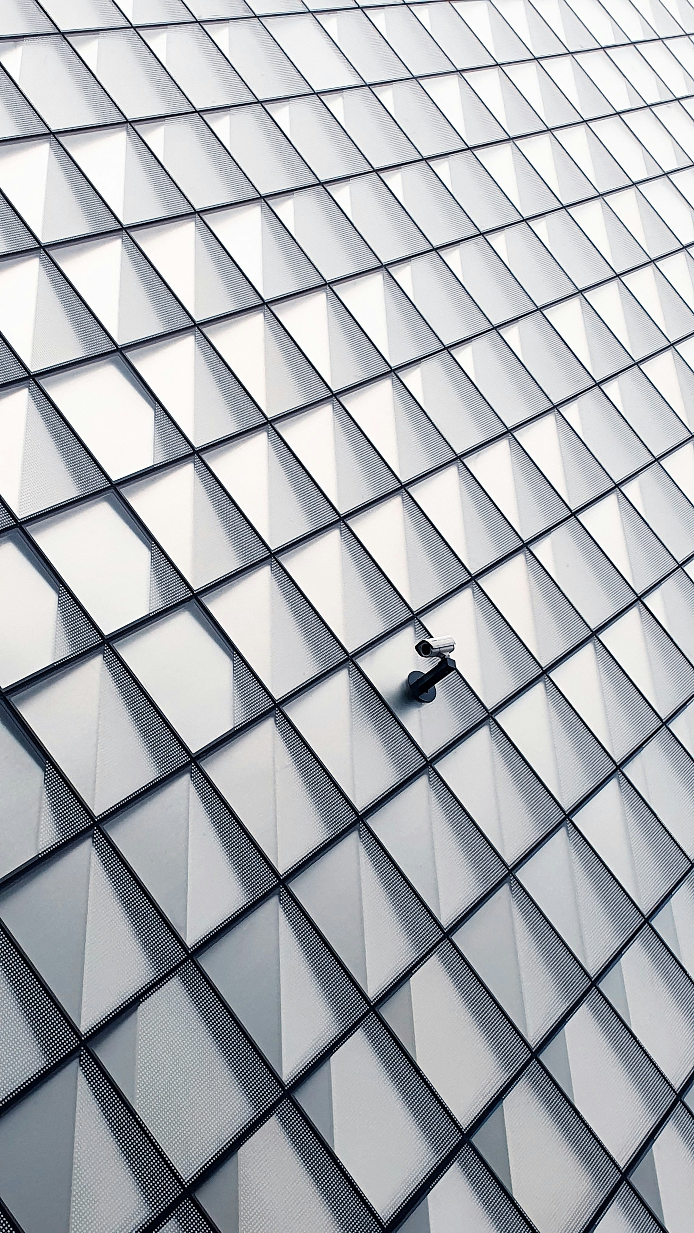 Lone surveillance camera located on the outside of the high tech museum Futurium in Berlin.