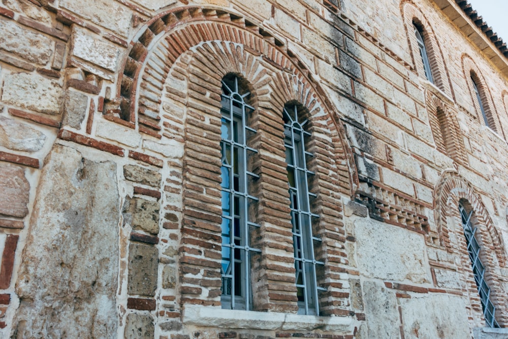 brown brick building with blue wooden windows