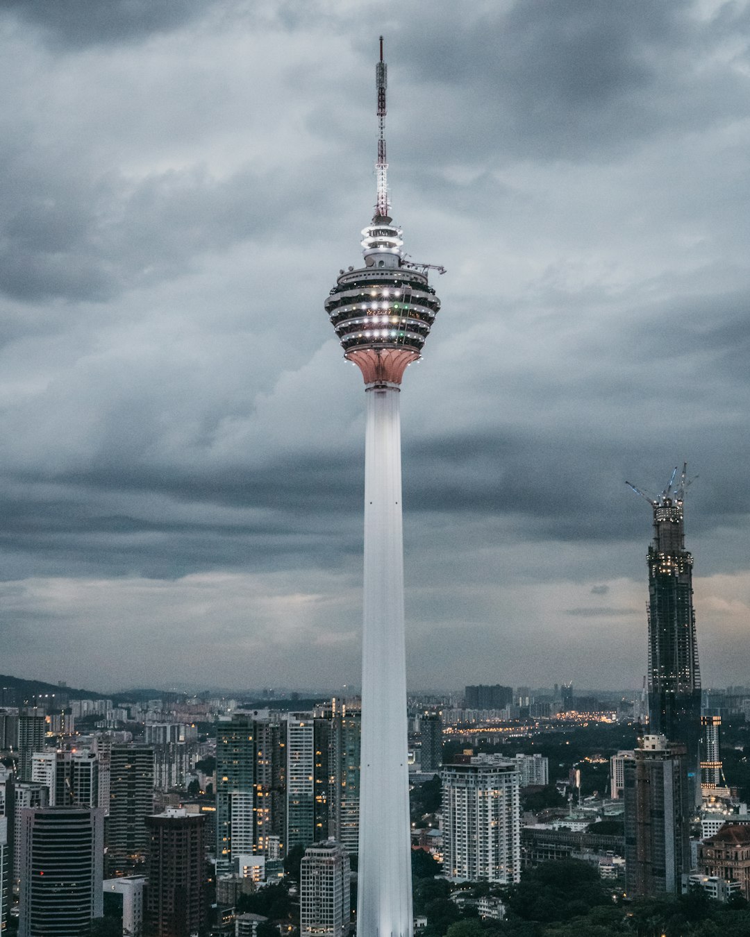 white and red tower under cloudy sky during daytime