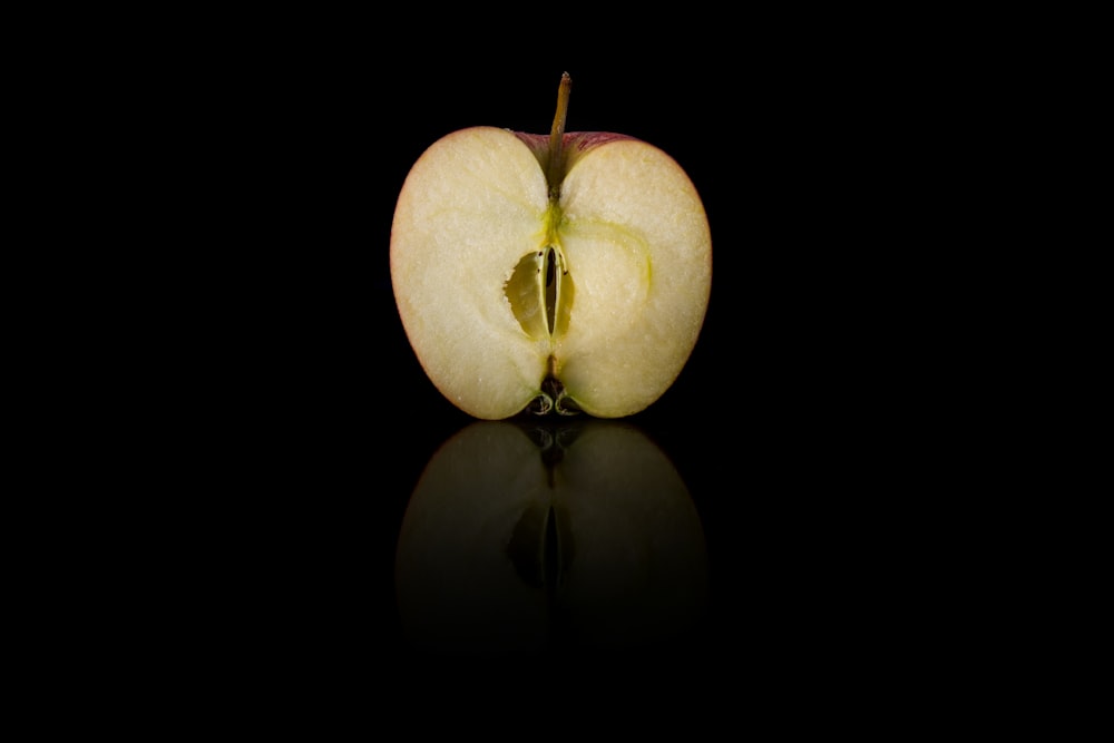 3 green apples on black background