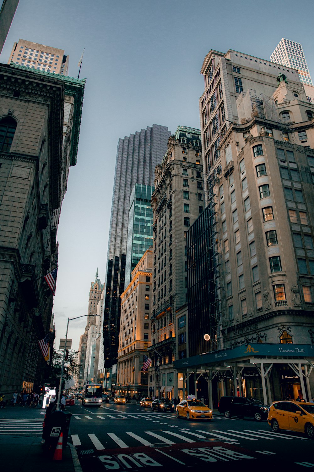 people walking on street between high rise buildings during daytime