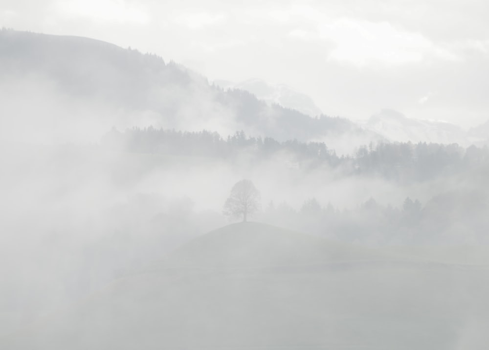 white clouds over mountain during daytime