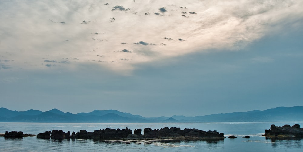 body of water under cloudy sky during daytime