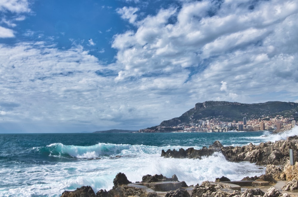 ocean waves crashing on shore during daytime