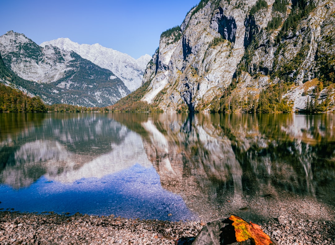 lake near mountain under blue sky during daytime