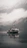 A vintage towboat cutting through misty river waters at dawn, framed by rust-colored autumn leaves.