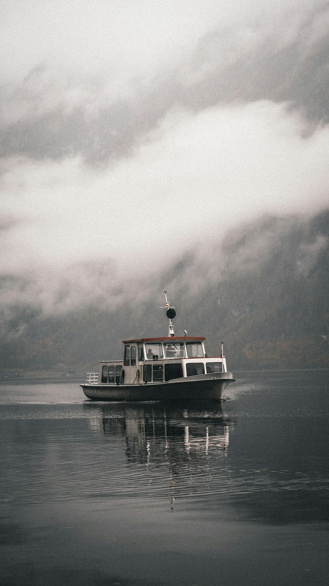 white and red ship on sea under white clouds during daytime