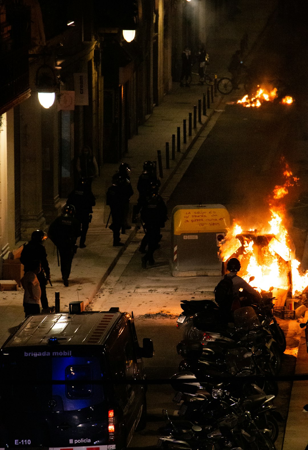 people walking on sidewalk near fire