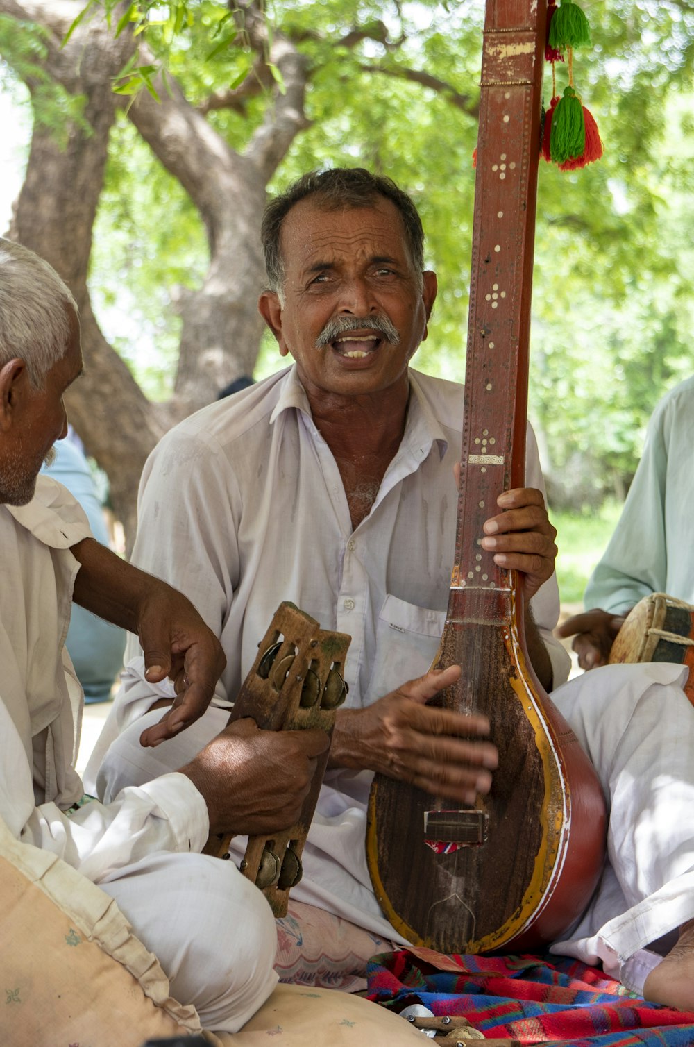 man in white button up shirt playing acoustic guitar