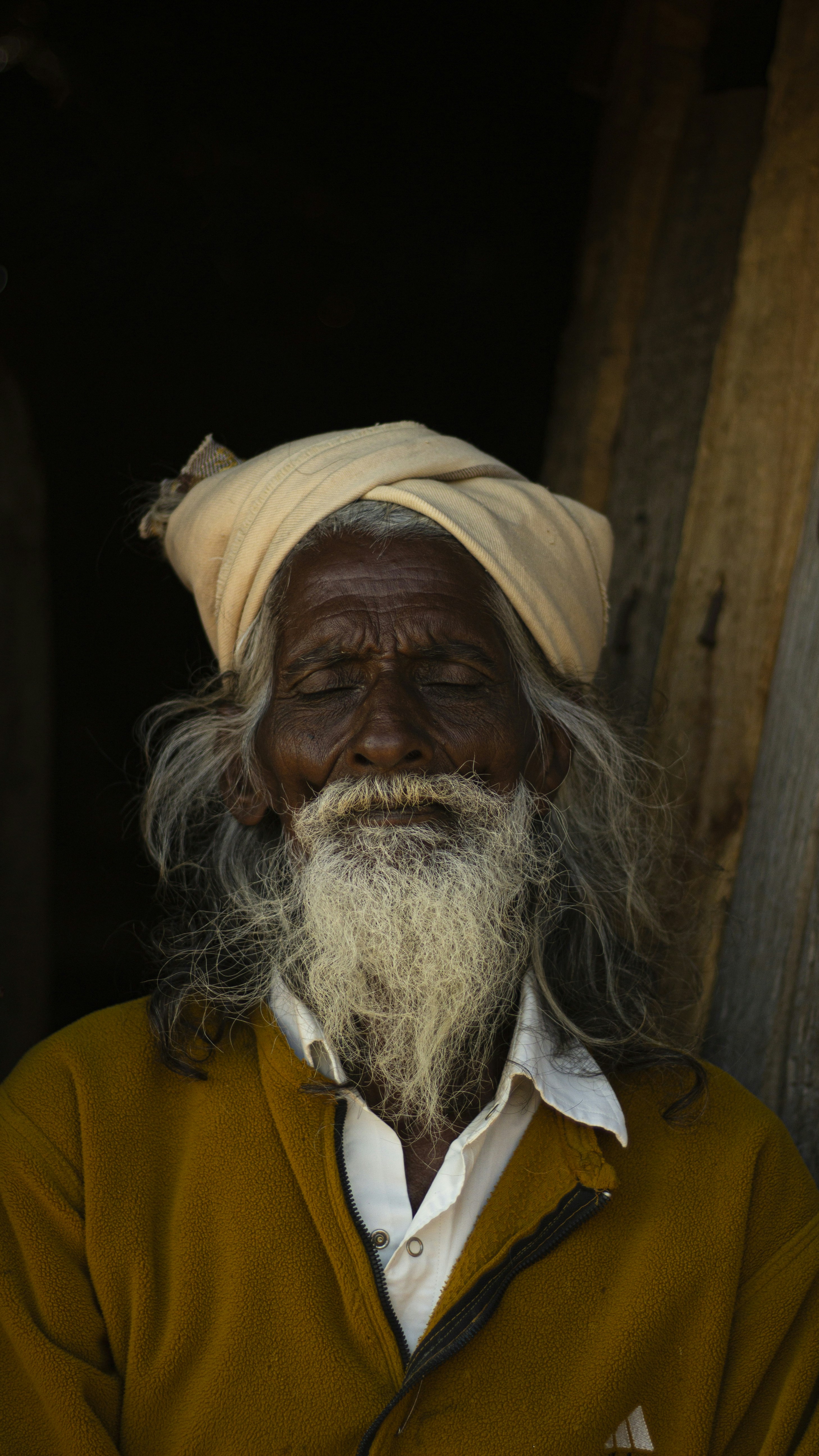man in yellow sweater with white scarf