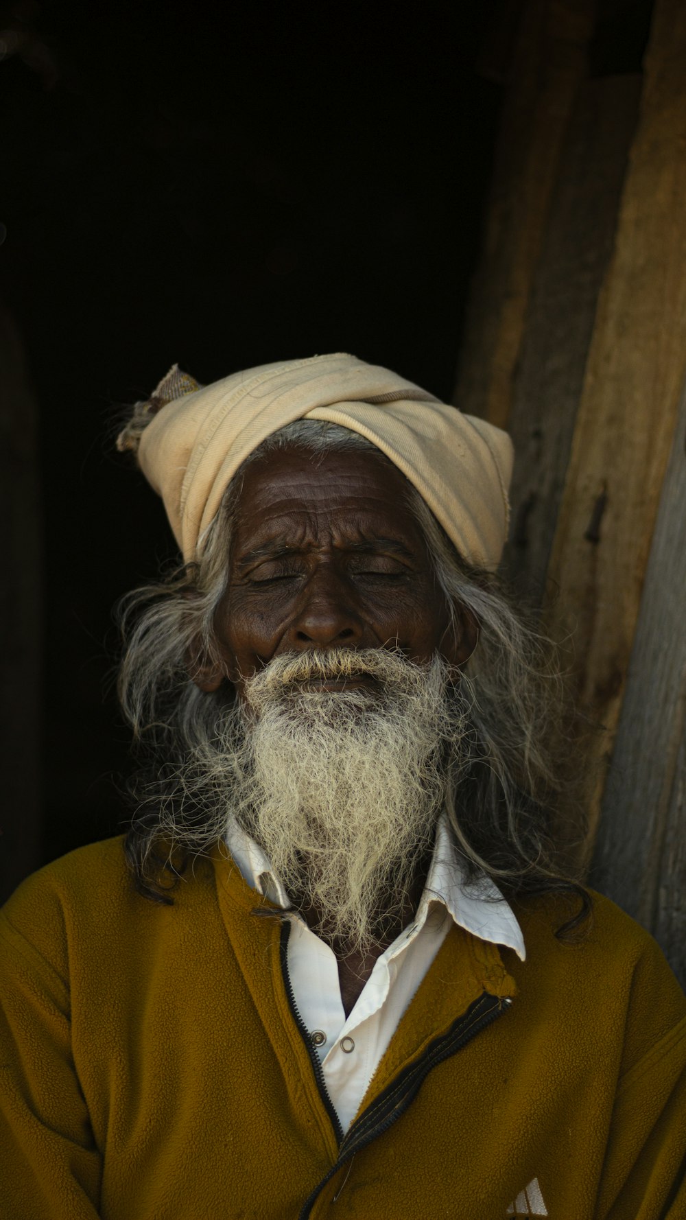 man in yellow sweater with white scarf