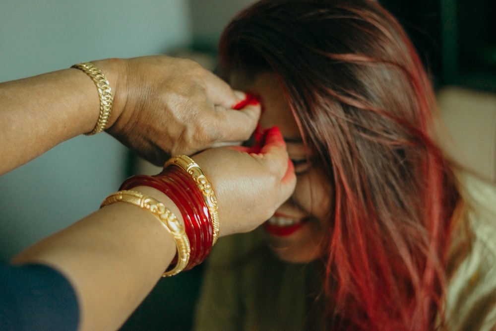 woman in gold bracelet and gold bracelet