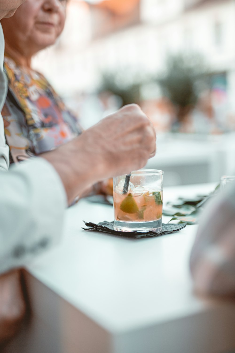 person pouring water on clear drinking glass