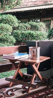 A foldable table being easily carried by a person through a bright, airy room.