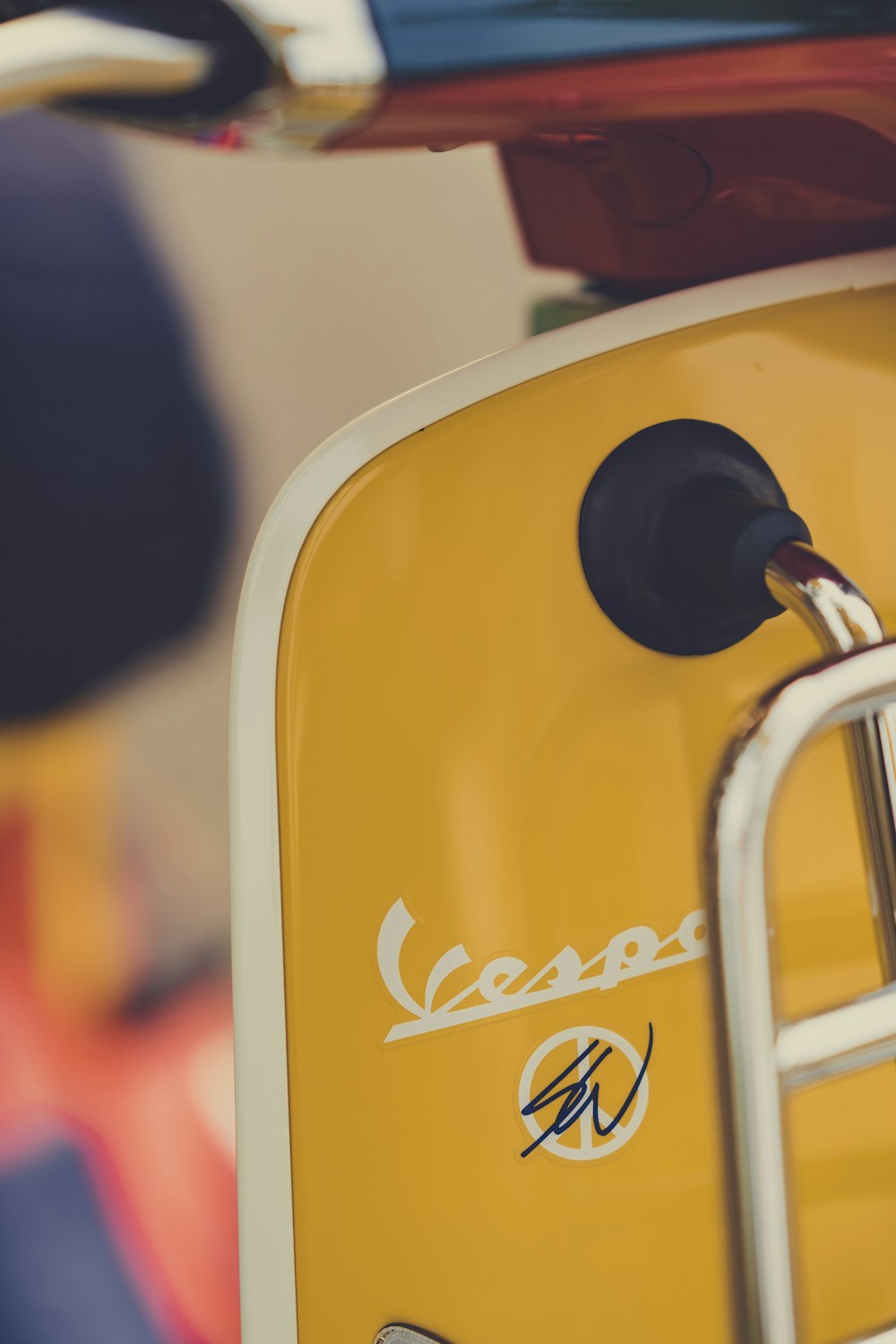 a close up of a yellow vespa scooter