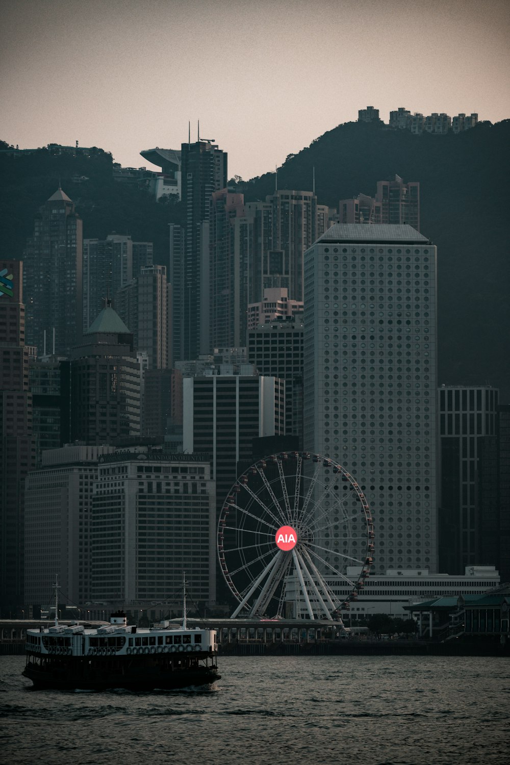 ferris wheel near city buildings during night time