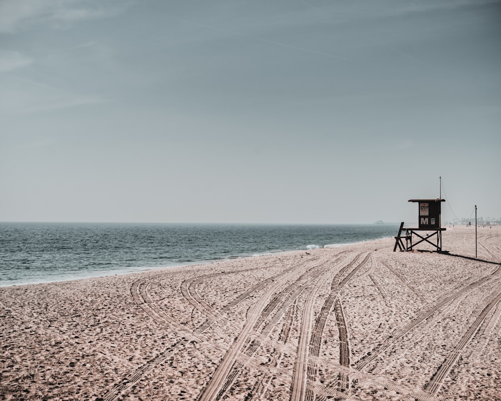 brown sand near body of water during daytime