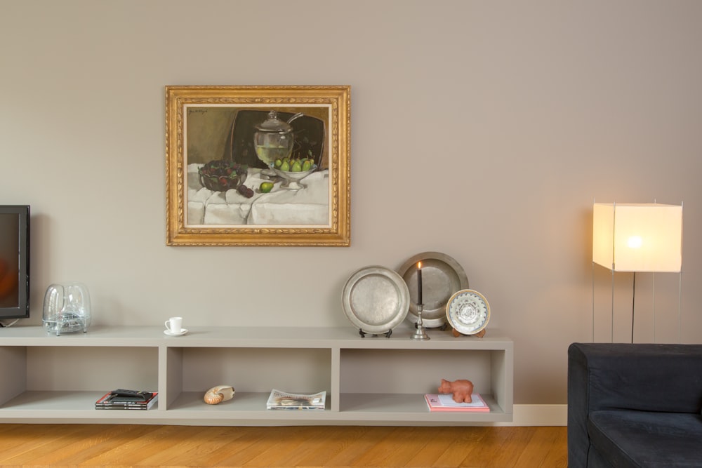 white ceramic tea set on white wooden shelf