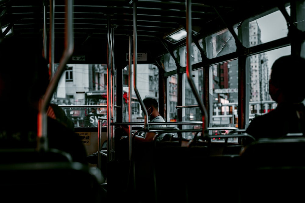 man in black jacket sitting on chair