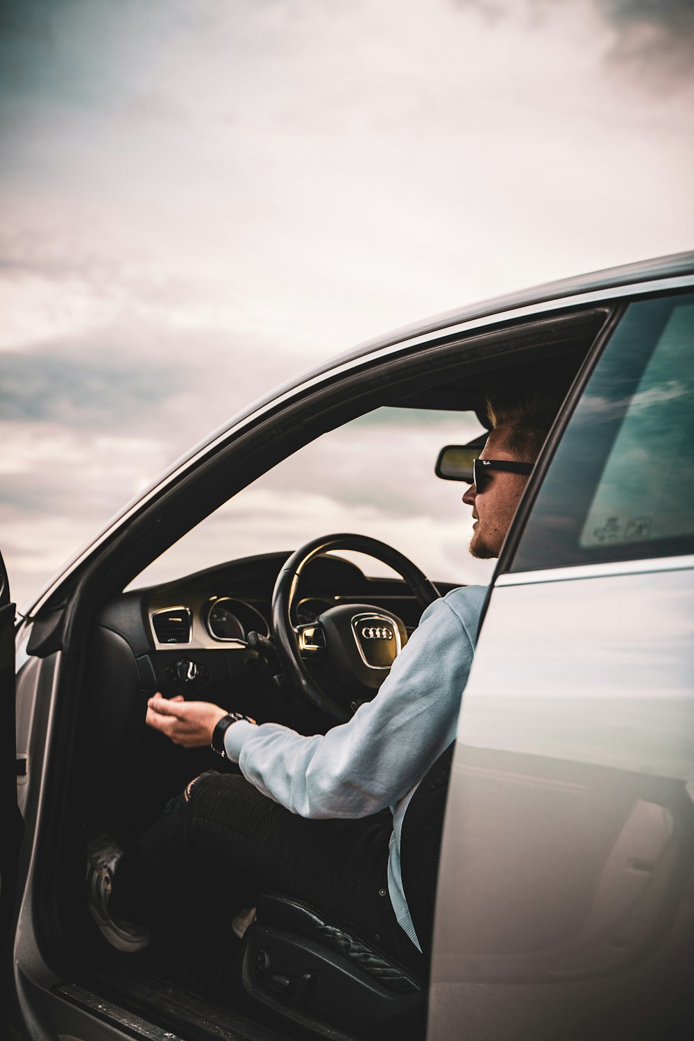 person in gray long sleeve shirt driving car