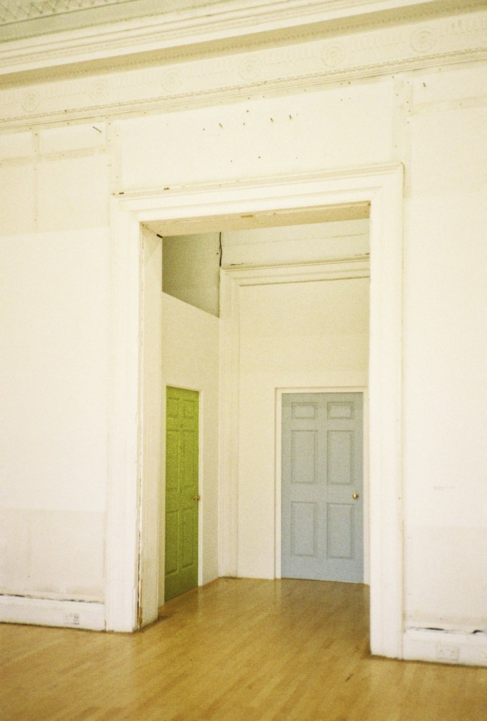 white wooden door on white painted wall