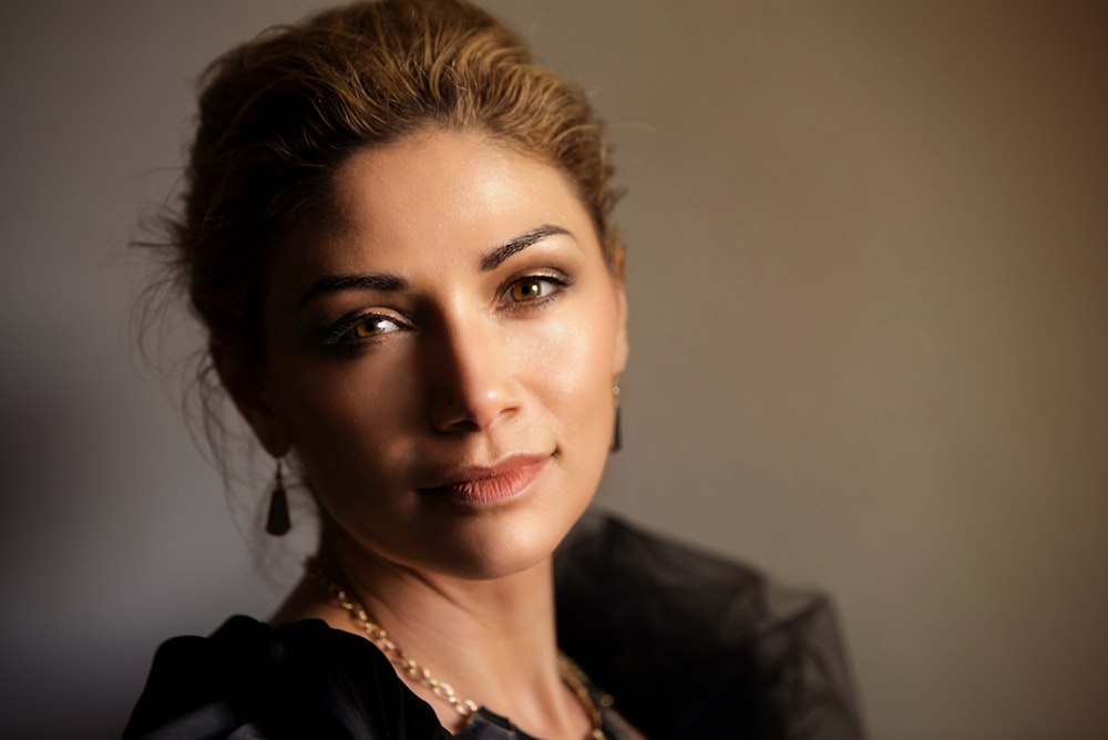 woman in black blazer and silver necklace